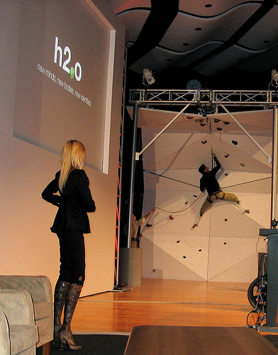 An artificially-legged person climbing a wall.