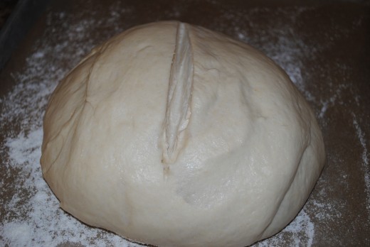 Immediately before baking, slash the dough across the top. This will not only form the classic loaf shape, but will allow the dough to expand correctly in the oven.