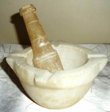 Mortar and pestle used for grinding insoluble solids into homeopathic remedies including quartz and oyster shells.