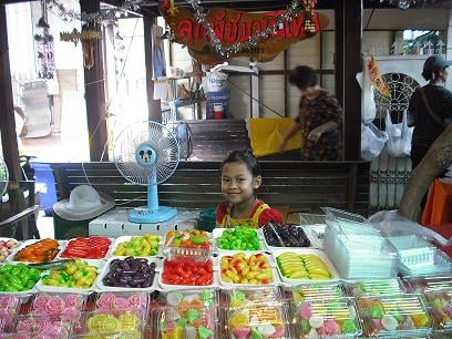 A little girl with Look Choob (Green Bean Miniature Fruit)and other Thai desserts