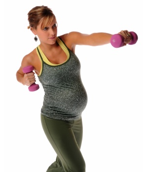 It's better to sit while weight training during pregnancy to prevent peripheral pooling of blood and muscle strain.