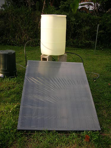 Composed of a 55-gal. drum, plastic irrigation tubing, and a piece of plywood. It is designed as a "thermosiphon unit" meaning that no pump is required to move the water, natural convection currents should do the trick! 