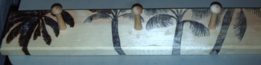 I created this free pyrography pattern by first drawing the palm trees on the jewelry rack.  Here I am beginning to smolder the image of the palm trees into the wood.