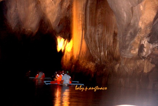 Stalactites and stalagmites abound around the underground river