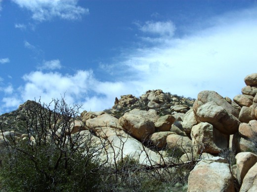 The beautiful blue sky and large boulders.