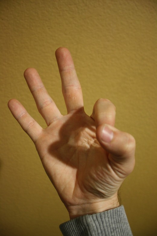 Index finger and thumb meet.