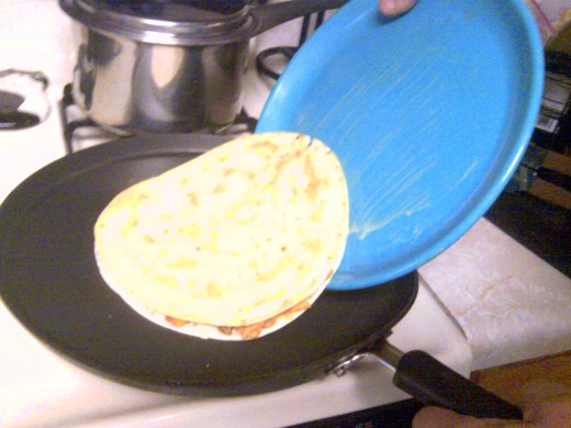 Place plate on pan, then flip so your'e holding plate face up, then slowly lift pan to check,when done slide on pan top side down.