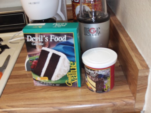 Here I am using my cheap $0.87 cent cake mix and $1.12 frosting mix that I bought at Walmart.  In my humble opinion these cheaper brands taste just as good as the more expensive name brands, but you use whatever you like as it is your cake.
