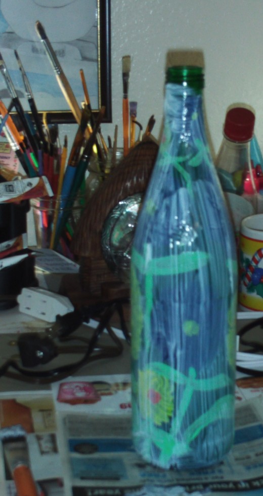I decided to seal the painting on the glass bottle with mod podge, which will give the vase a lustrous glow.  I let the vase dry overnight before I moved it.