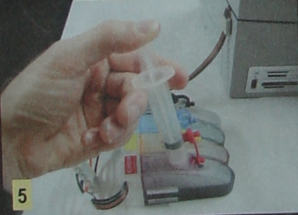 Step 5:  Slowly fill the bottles one at a time.  If you shoot it in too fast, the ink can bubble and splash.  Be careful not to overfill the tanks. 