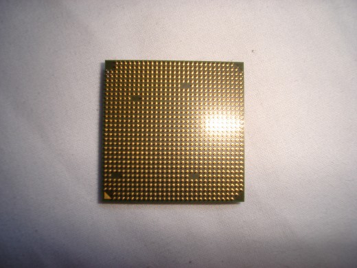 Bottom of a AMD 4200+ x2 processor. Notice all the little golden pins.