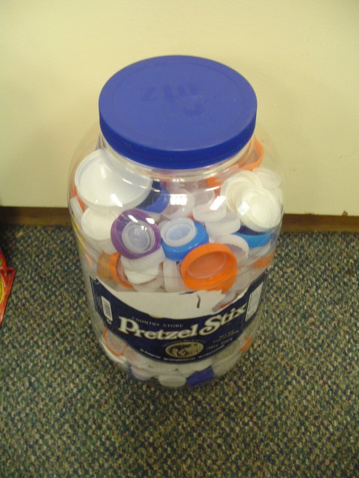 Students bring their bottle caps for recycling purposes
