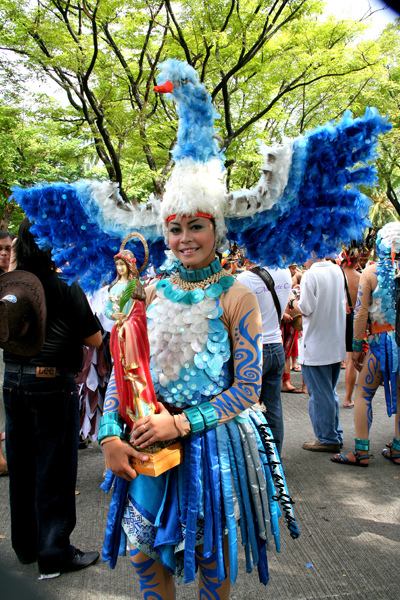 participant carrying a statue of the Blessed Virgin Mary