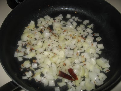 Heat chopped onions, garlic, and ginger in pan.