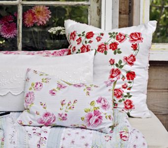 These floral pillows, although different colors, go well together because they have the same background color and similar feel.