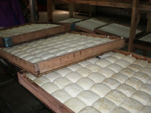 The finished tofu is collected on  large trays.