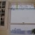 Window with great view and glass shelf holding clear glass bottles. Window with great view and glass shelf holding clear glass bottles.