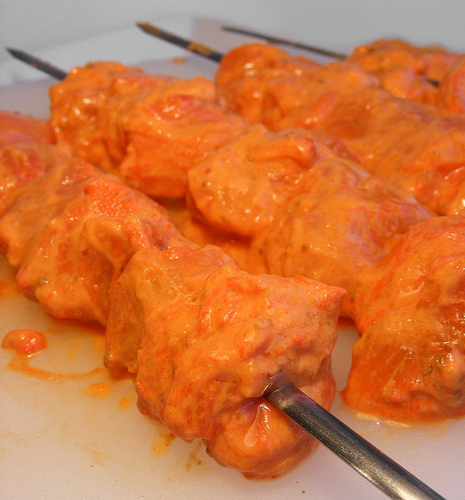 Boneless chicken pieces marinated with spices and yogurt skewered and ready for the Tandoor