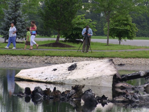 Curious onlookers arrive on the church grounds to examine the remains of "Big Butter Jesus." Photo: Greg Reese Mom&Son