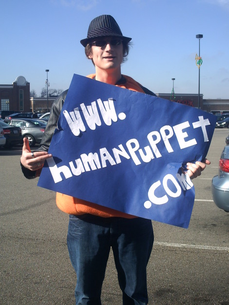 Forest Thomer, The Human Puppet, displays his sign outside the Sarah Palin Book signing in Cincinnati.