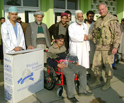 Joint Task Force Afghanistan (JTF-Afg) Deputy Commander Colonel Fred Lewis shakes the hand of a doctor at Mir Weis Hospital in Kandahar City, as the hospital accepts a donation of wheelchairs from Wheelchair Foundation Canada (WFC).   