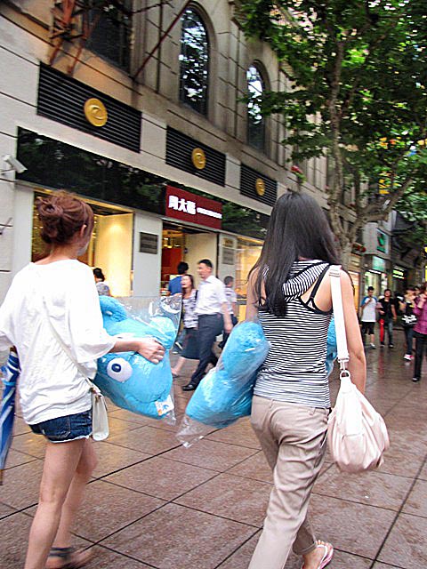 Shoppers carry World Expo souvenirs