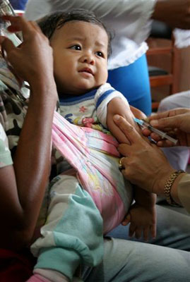This infant is one of nearly 30 million Indonesian children receiving a measles vaccination.     