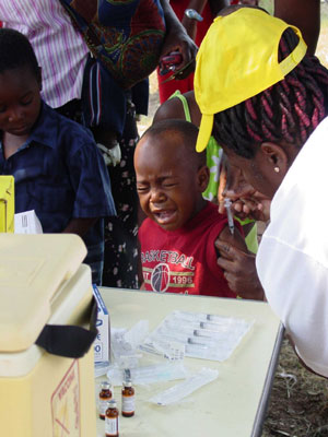 This Mozambique boy manages his measles 'jab' the best he can...  