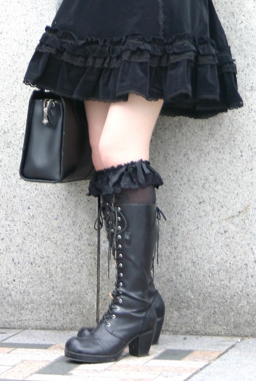 This is a another great example of a stunning outfit seen on the streets of Tokyo's fashionable Harajuku district. Black laceup boots are a classic gothic clothing staple. Here they are combined with lacy black knee length socks.