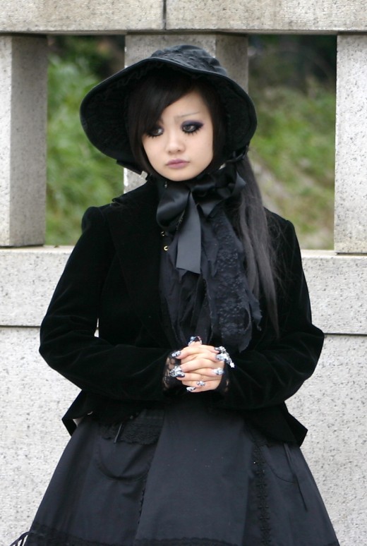 A stunningly beautiful outfit straight from Harajuku. Lots of lace, lots of black. This is a Victorian inspired black gothic lolita outfit. Notice the elaborate nails which are truly wonderous as well as the beautiful eye makeup.