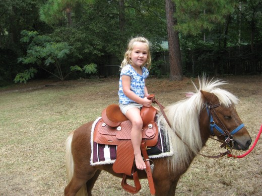 Audrie riding Snickers at Lexi's birthday party.