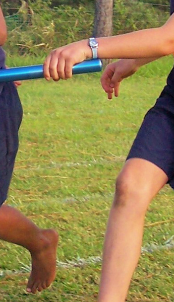 The athlete on the right should see that the athlete ahead of her has the other hand out and try pass it into that hand rather than into her hip. The athlete on the left could have made it easier for her by standing well to the left side of the lane.