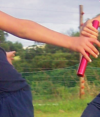 This pass is not too bad, although the athlete on the left could have had his hand a little lower to make it easier for the athlete on the right to swing the baton UP into the hand. The athlete on the right should have also swung more of the END part