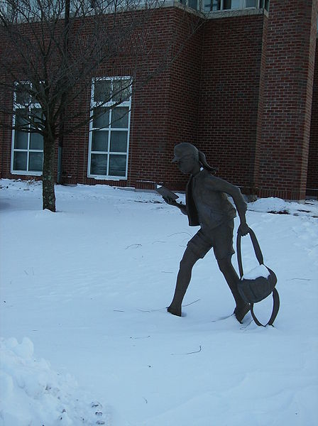 Statue of a girl reading, found at the Newton Free Library.