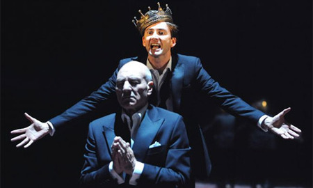 Prince Hamlet (David Tennant) behind praying King Claudius (Patrick Stewart) scene from the BBC movie "Hamlet".