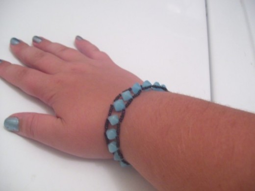 This bracelet is done with stretchy cord and the ladder stitch for a great look that is also easy to wear. 