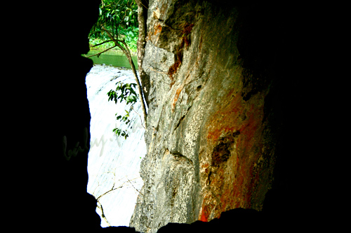 a tunnel framing a waterfalls