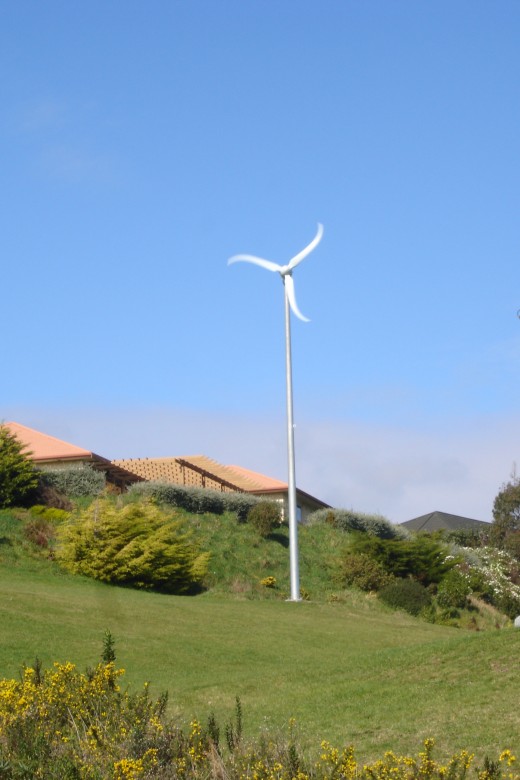 A commercial home windmill in a semi-rural setting.