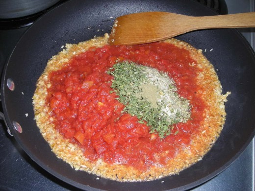 ADDING THE TOMATOES AND SPICES