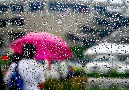 raind through the window of a slow moving car caught in traffic