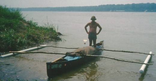That's me standing in our modified canoe.  Notice the protective canvas (mentioned earlier) unbuttoned and rolled up from both ends of the canoe.   The paddle in the water behind me is actually tied to the canoe. 