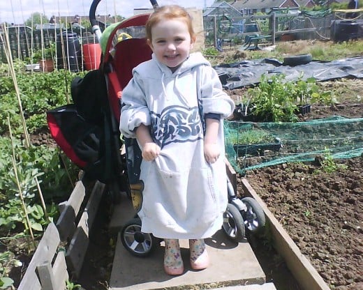 My daughter in the allotment, complete with wellies and her dad's hoodie.