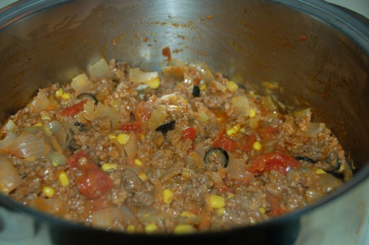  Tomatoes, salsa, black olives, and whole corn ready for the casserole dish.
