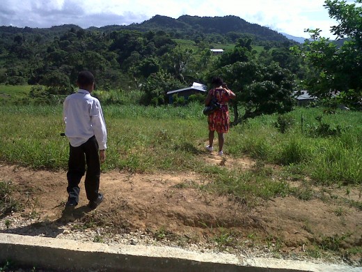 Son and wife taking path downhill to family home.  Photo by Glendon Caballero.