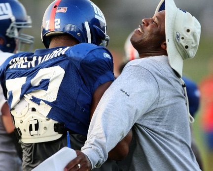Defensive coordinator Perry Fewell, left, chest bumps Giants defensive end Osi Umenyiora. Photo - Noah K. Murray/ The Star-Ledger