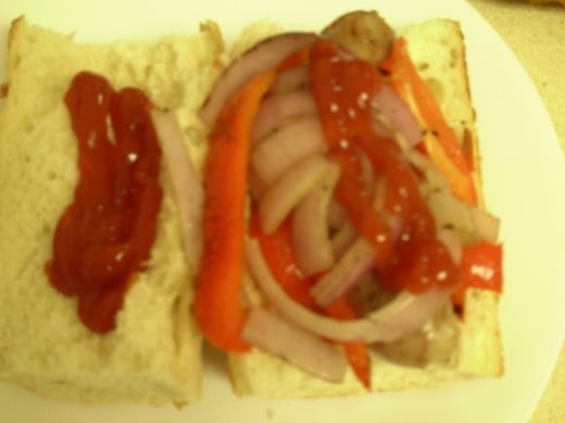 Italian Sausage Sandwich with Red Bell Peppers and Red Onions and Ketchup