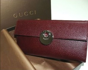 Buy a Gucci leather checkbook wallet