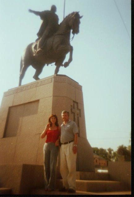 My wife and I posing beneath the Statute of Alexander Nevsky a thirteenth century Russian military hero and Prince of nearby Novogorod