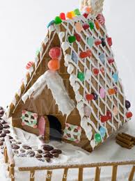 Royal icing is great to use as 'glue'.  Gingerbread houses are excellent for showing off your edible glitter colors also.
