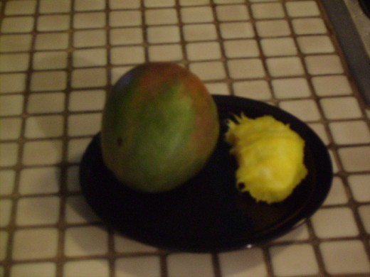 Another photo of a mango and seed for size comparison.
